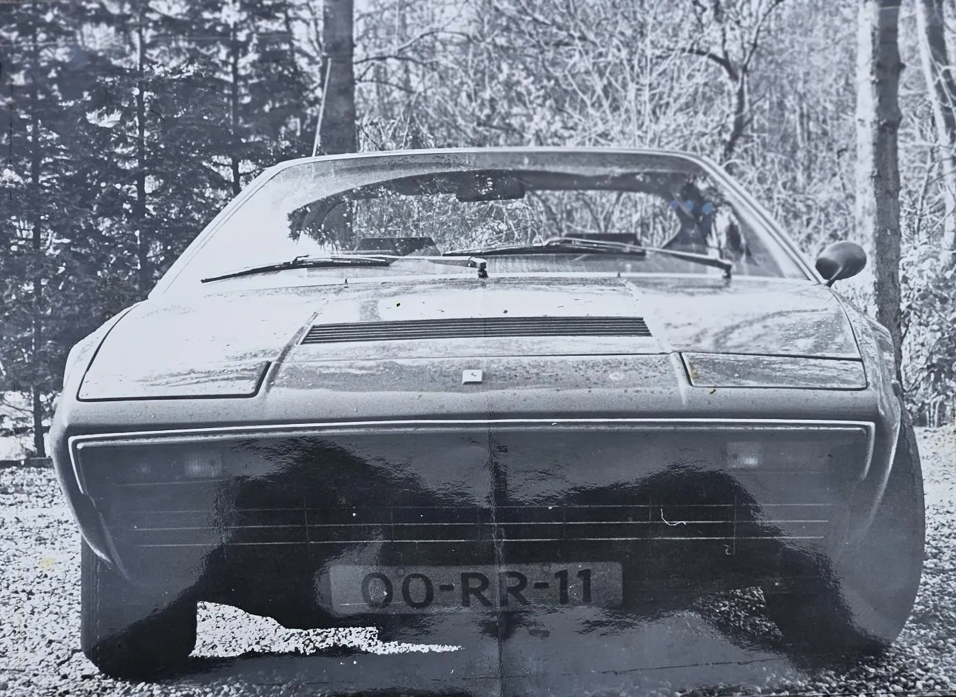 Black-and-white photograph of the 308 GT4 from the front, with registration 00-RR-11