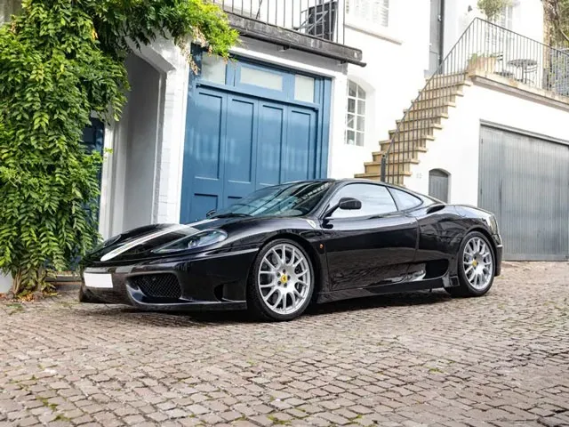 A black Challenge Stradale with a tricolore stripe, seen from the front left