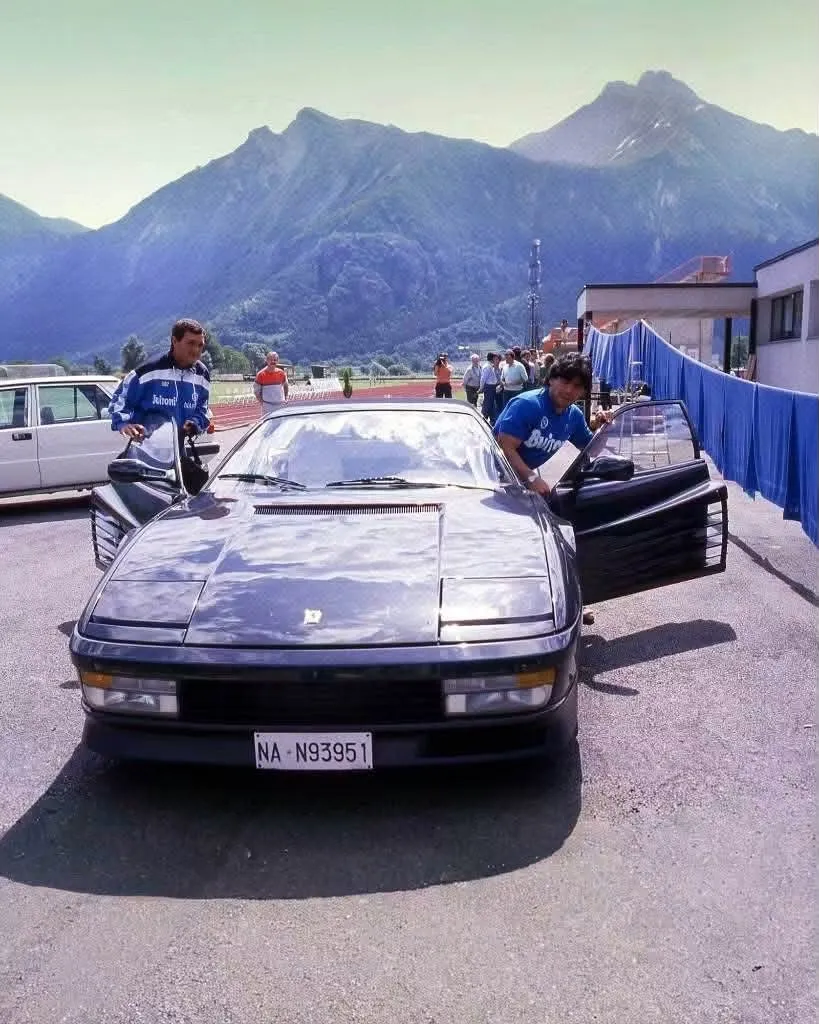 A black Testarossa with its doors open, bearing registration NA N93951
